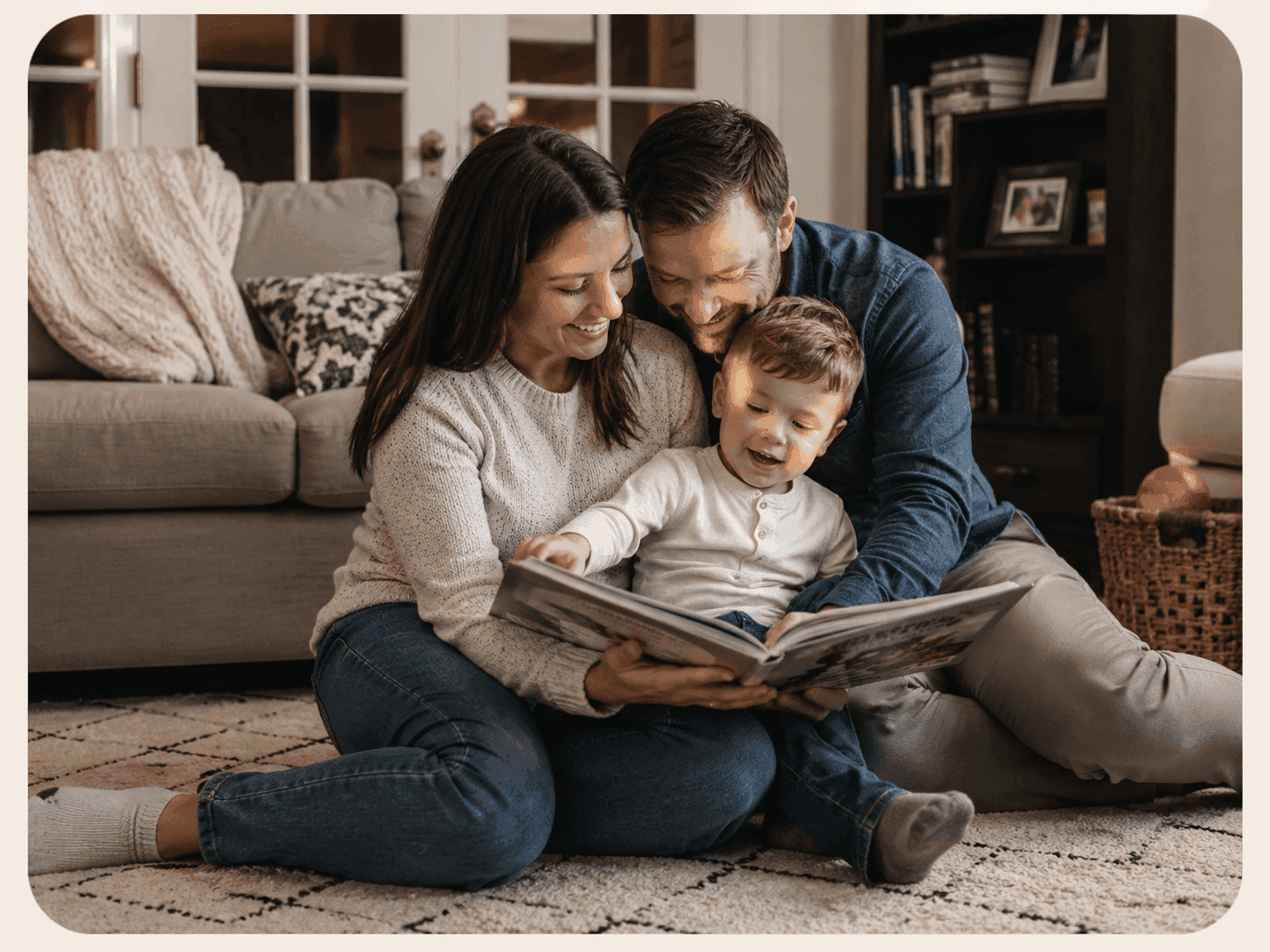 A mother, father, and young son reading a picture book together