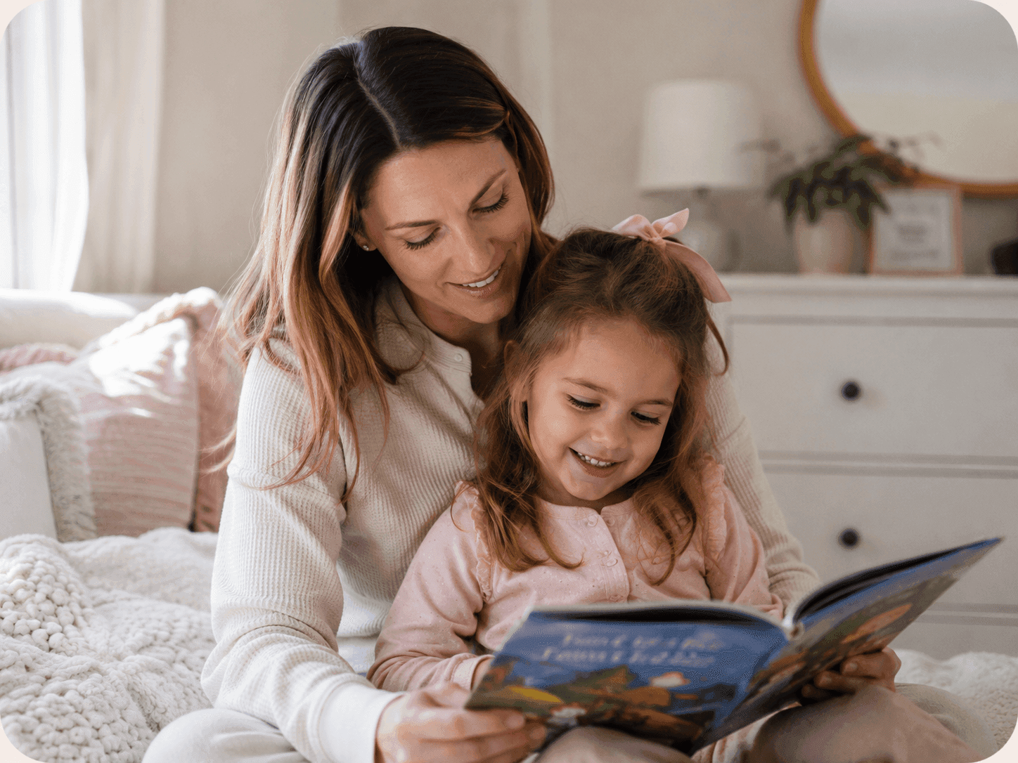 A mother and daughter reading a book together